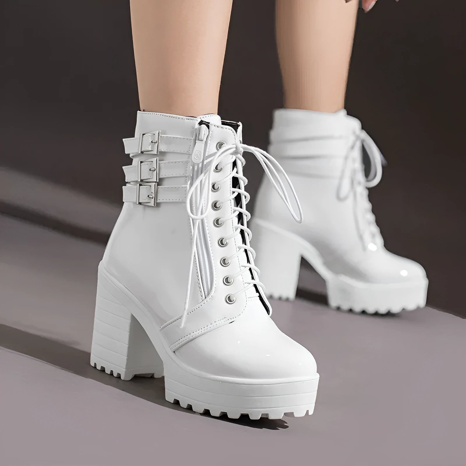 Women's black thick-heel short boots with front lace-up and round toe on a waterproof rubber sole.