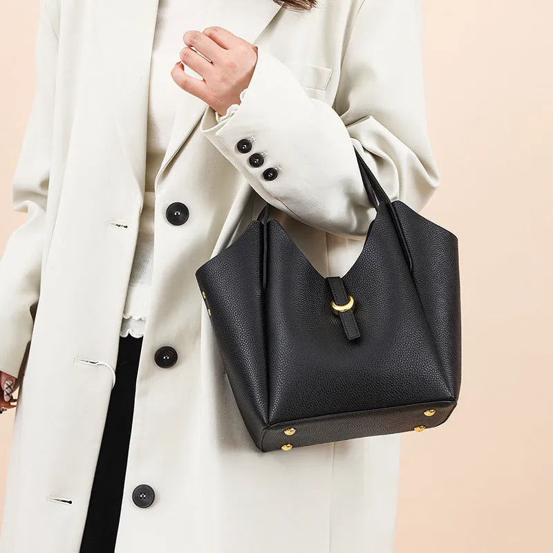Genuine leather women's bucket bag in hand-held style with visible stitching details