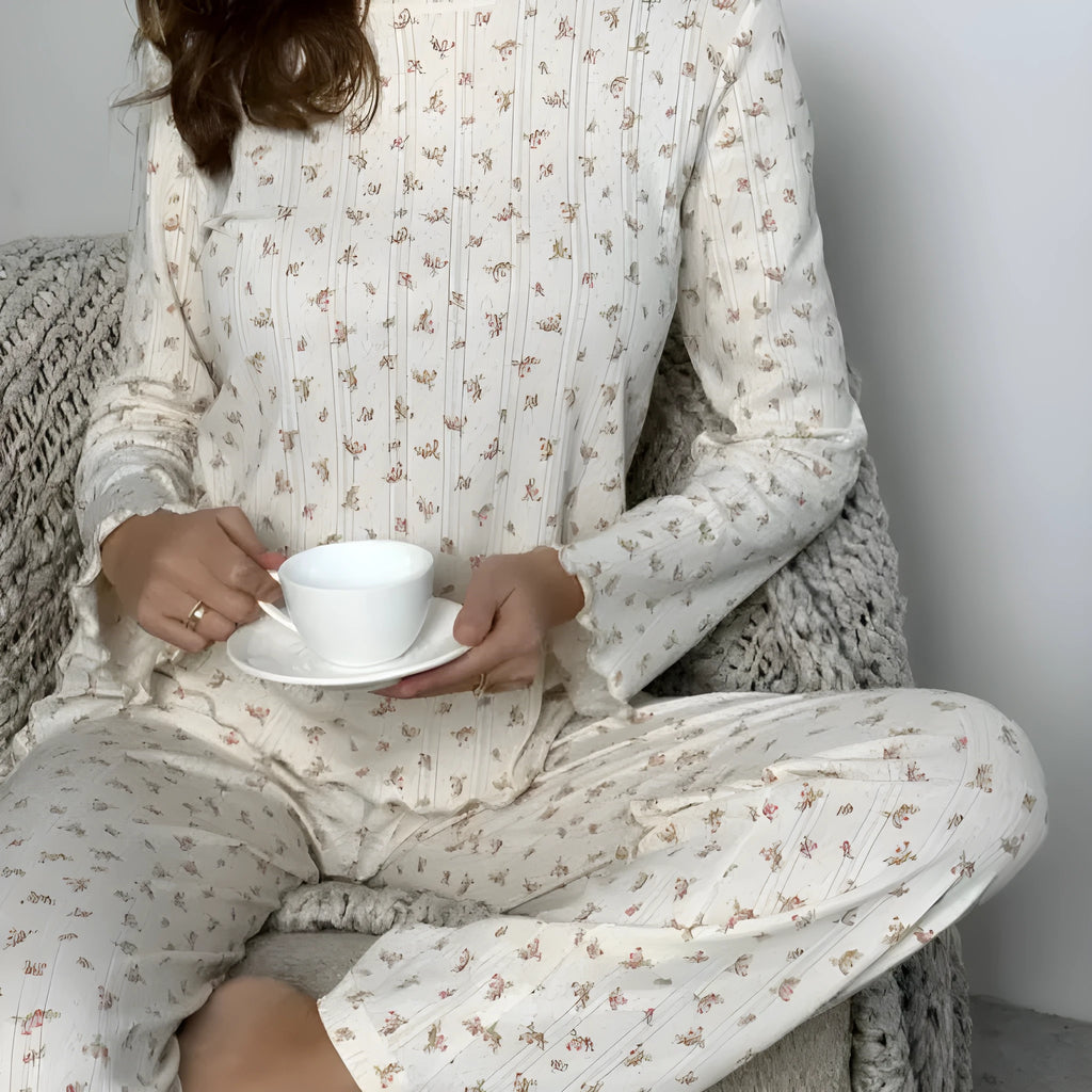 White floral print women's pyjama set with bell sleeve top and wide-leg trousers.