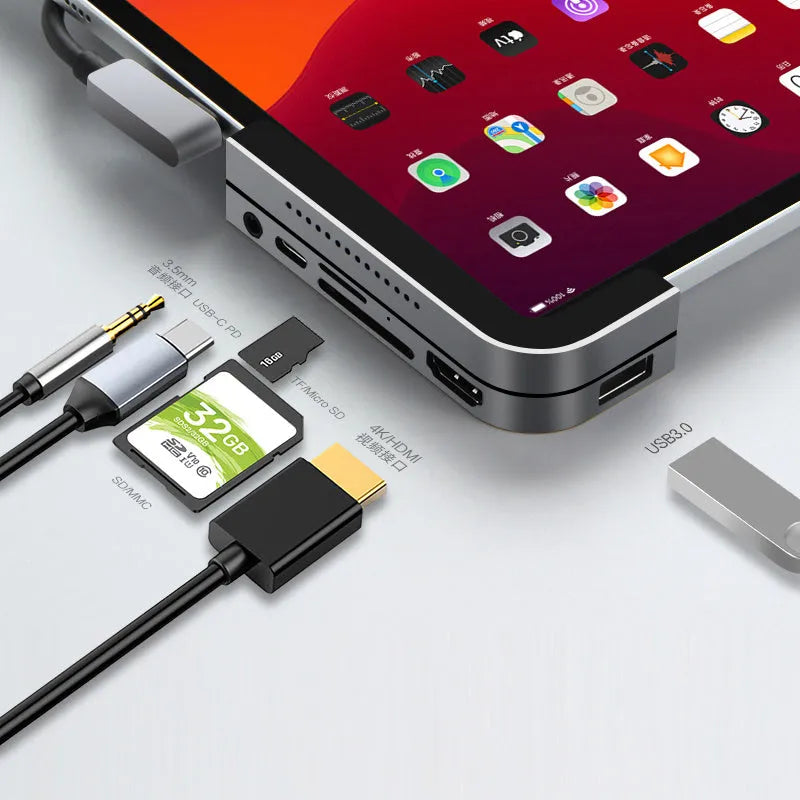 Silver aluminium grey USB-C docking station and multi-port converter for iPad Pro models.