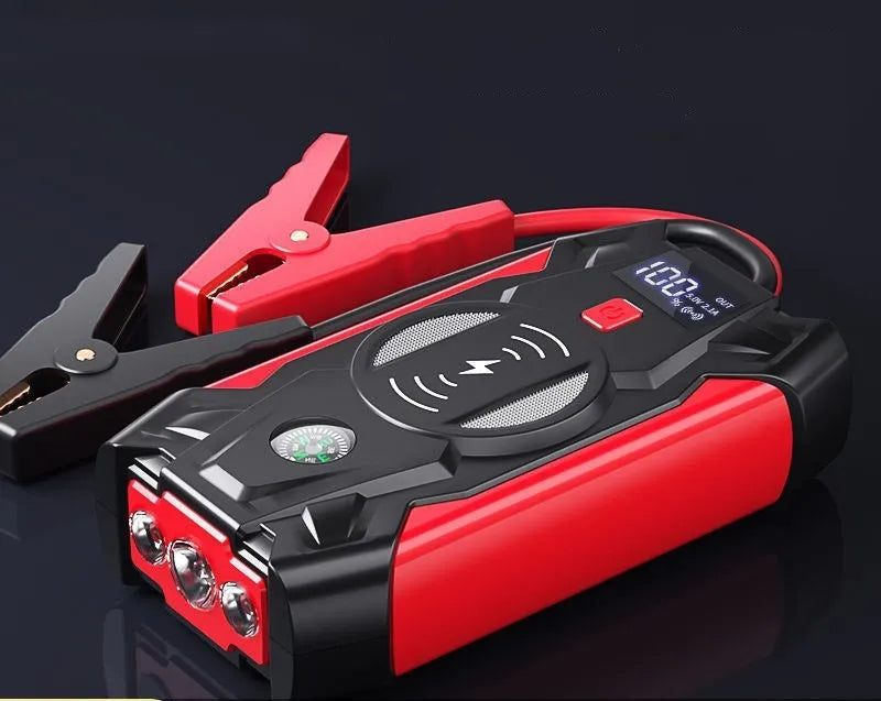 Red car emergency jump starter with digital display and thick battery clips