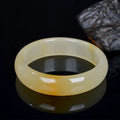 Natural light jade bracelet with polished surface in traditional Chinese style showing size options