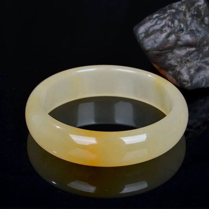 Natural light jade bracelet with polished surface in traditional Chinese style showing size options