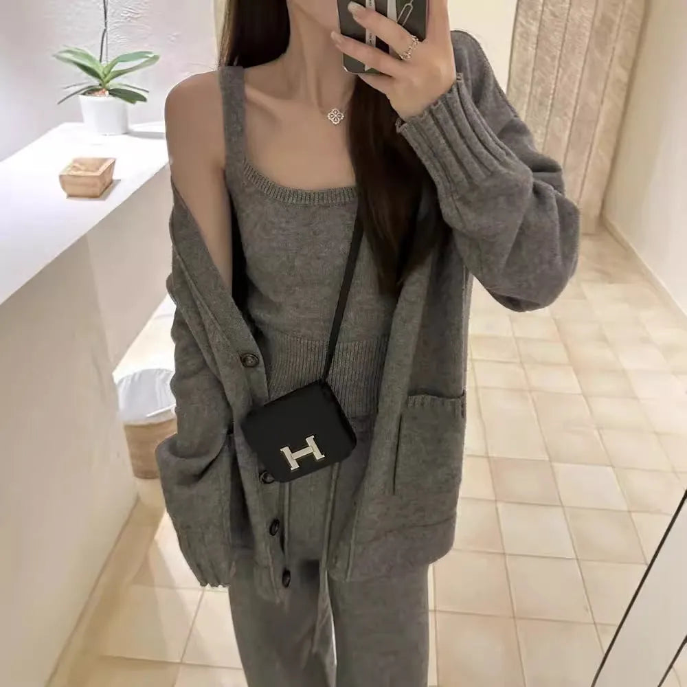Women's loose-fit wool-blend cardigan three-piece set with vest and suspender trousers in beige.