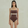 Brown triangle top one-piece swimsuit for women on a hanger.
