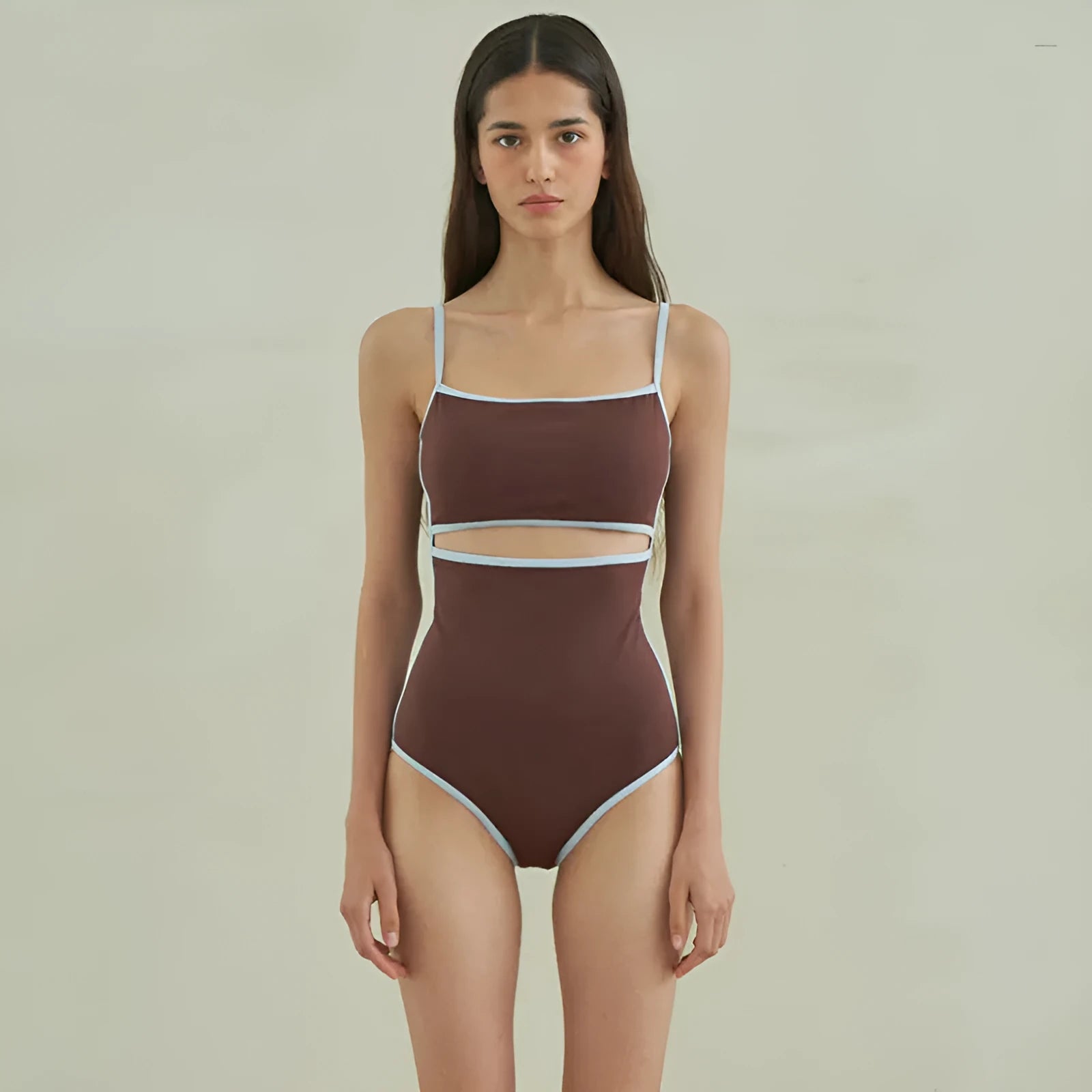 Brown triangle top one-piece swimsuit for women on a hanger.