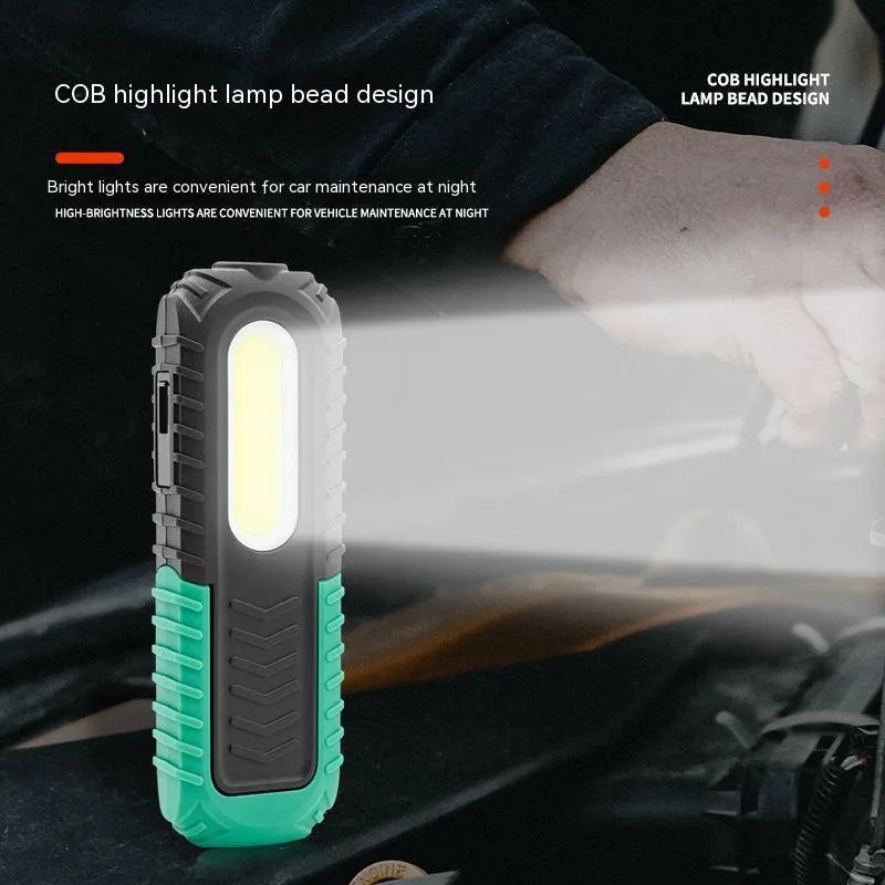 Black and green USB auto repair work light with compact design for workshop use