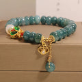 Blue water jade bracelet with white agate abacus beads and butterfly charm