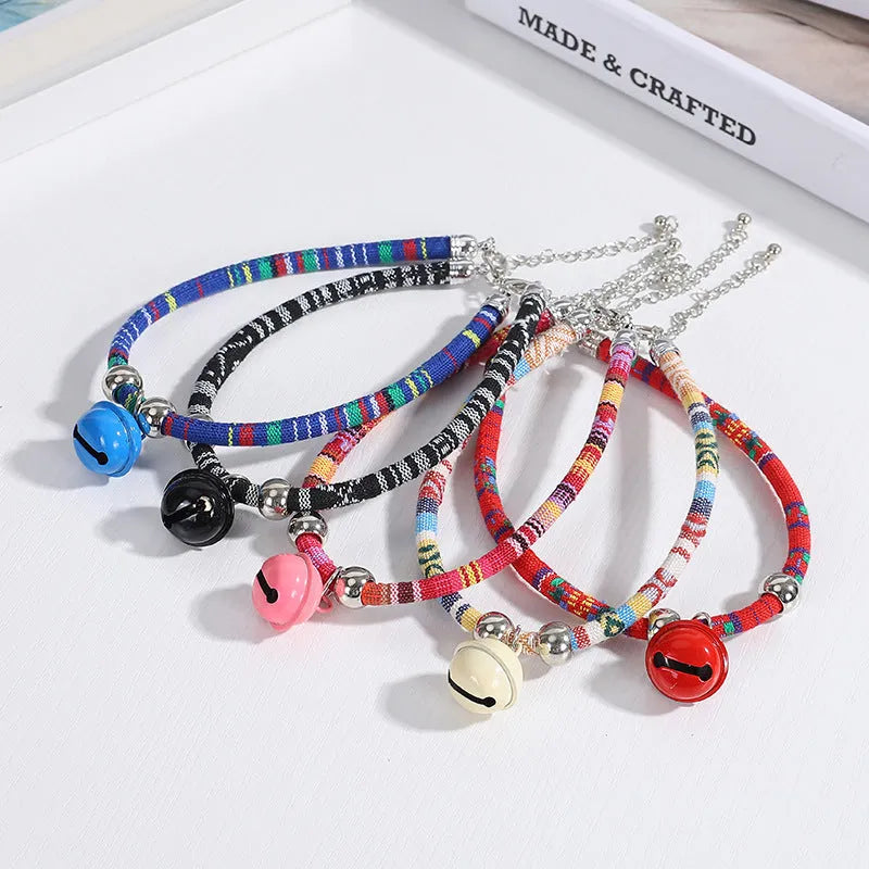 Coloured ethnic-style adjustable pet collar for dogs and cats with a small bell, shown in multiple colour options.