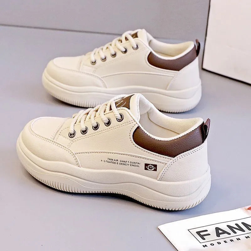 Women's white Korean-style low-top pumps with cross straps and lace-up front on a rubber sole.