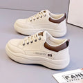 Women's white Korean-style low-top pumps with cross straps and lace-up front on a rubber sole.