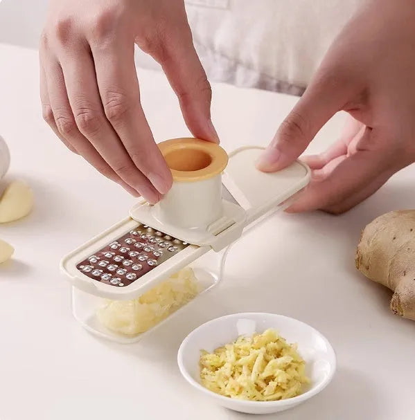Stainless steel ginger and garlic grinder three-in-one potato slicer in beige on kitchen counter