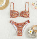 Women's floral bikini swimsuit with high-waisted briefs in solid orange colour