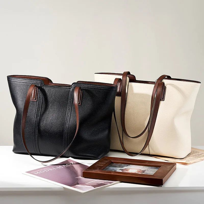 Black genuine leather women's shoulder bag showing internal organiser pockets and crossbody strap