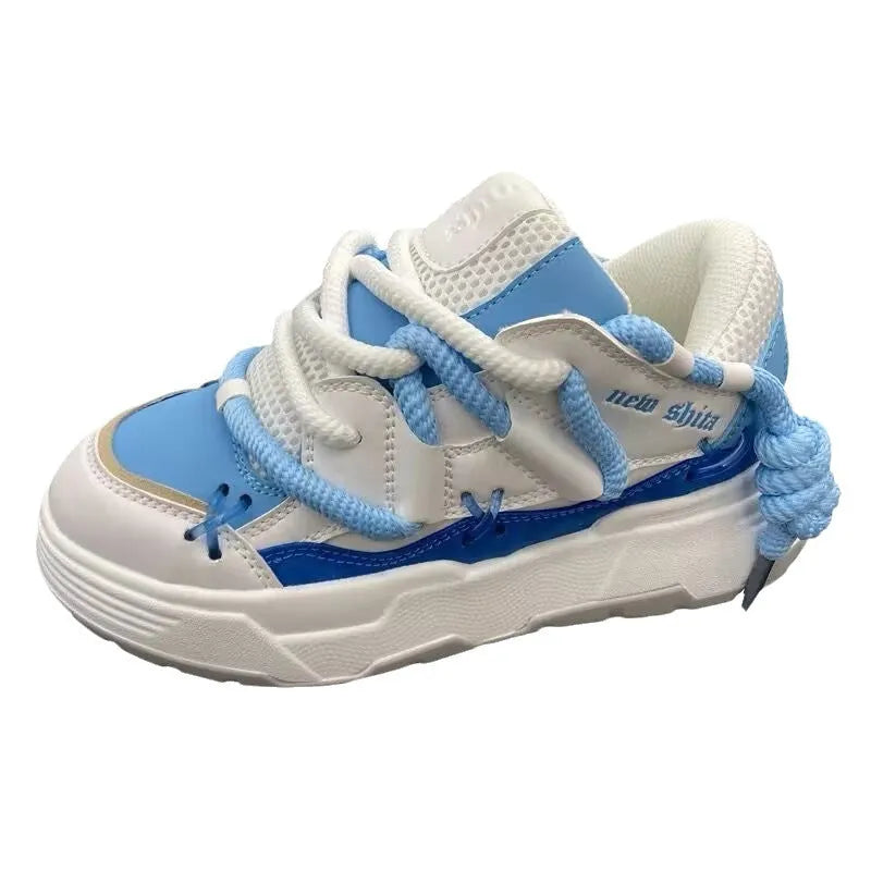 Grey women's chunky lace-up sneakers with a thick rubber sole and retro design on a white background.