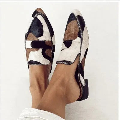 Women's black and white apricot retro pointed-toe low heel suede shoes with imitation horse hair pattern on a white background.