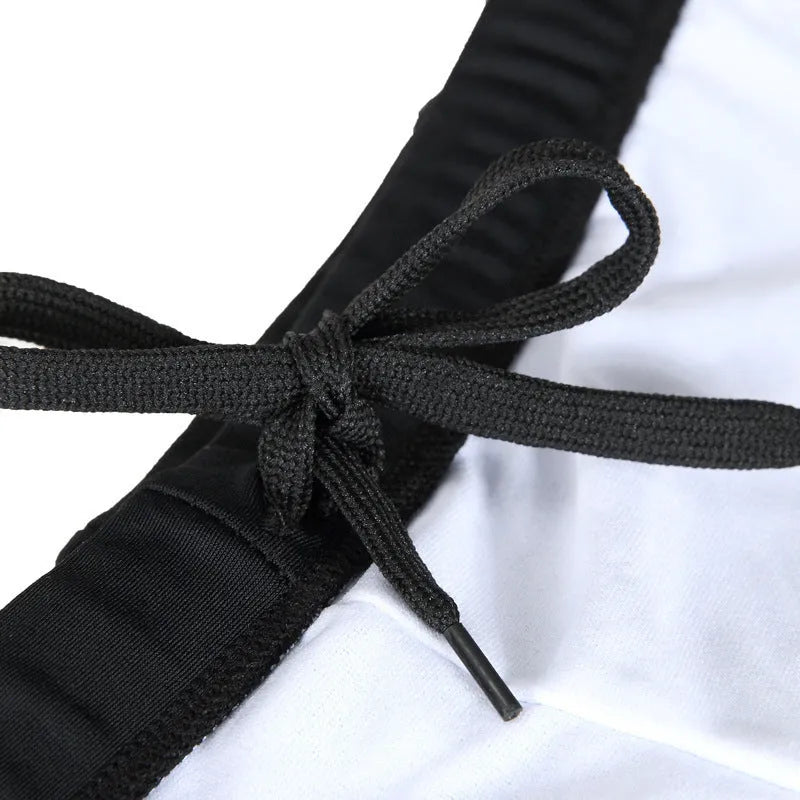 Men's boxer style swimming trunks with matching cap in blue fire design on black background
