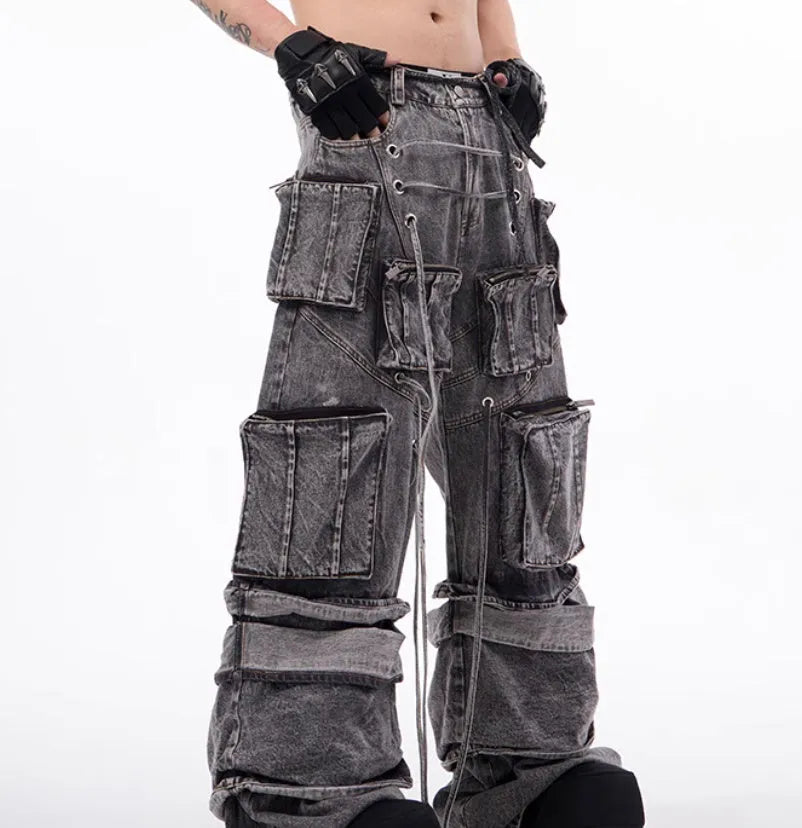 Grey denim distressed overalls with rope stitching and a wide-leg mop pants silhouette.