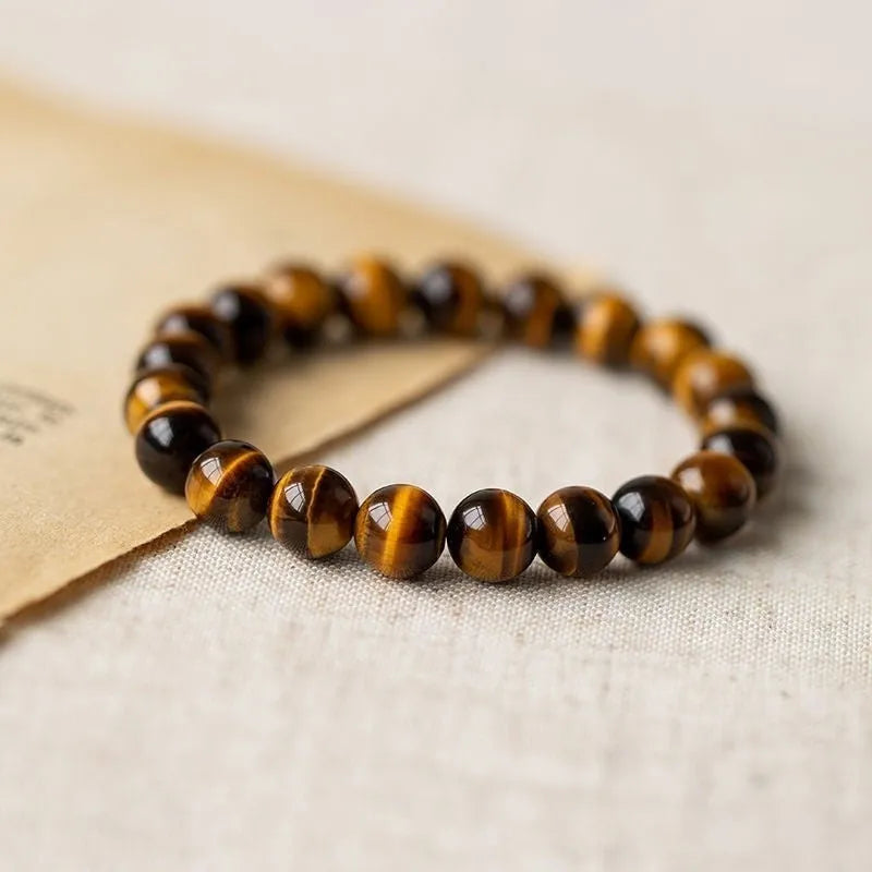 Single circle tigereye Dzi bead Buddhist mala bracelet shown on a wrist.