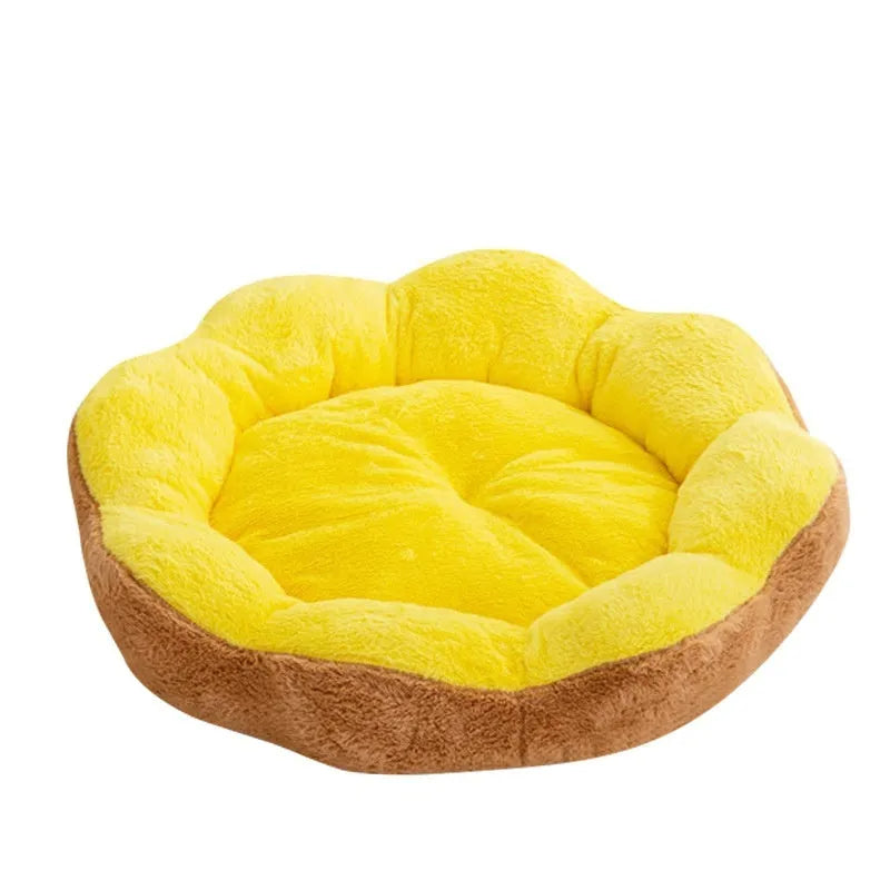 A round, thick plush cat bed with a removable cover shown in a two-tone colour, placed next to a cat toy.