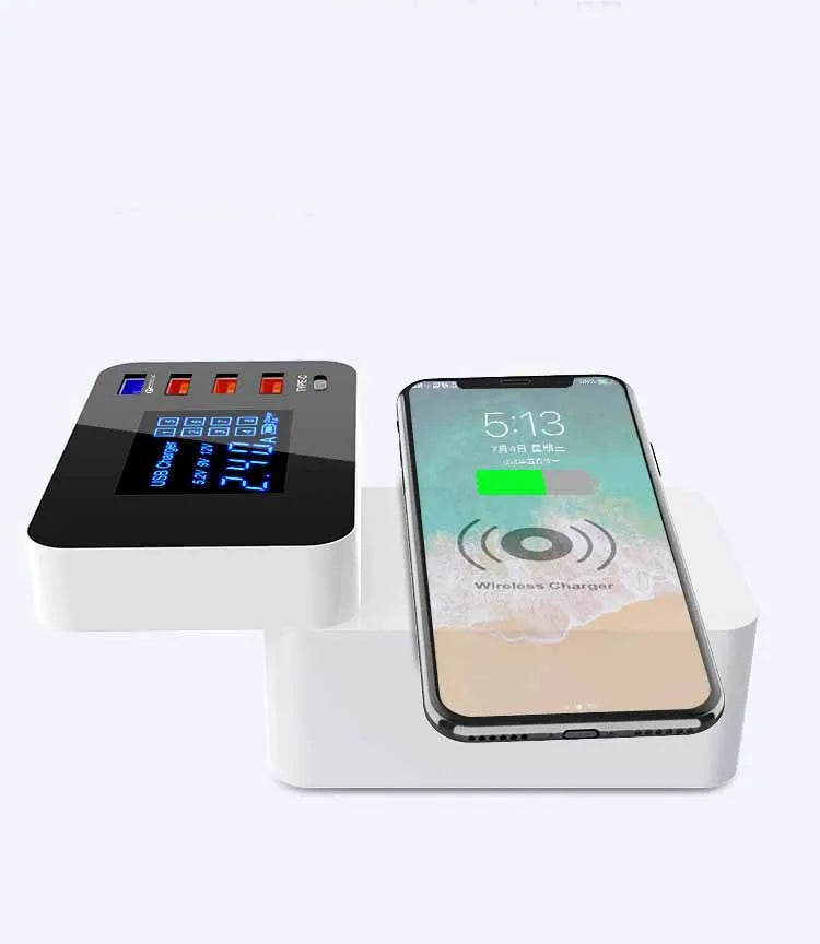 White multi-port USB and wireless fast charger with international plug adapters on a desk