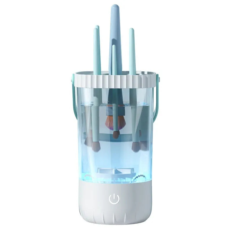 White rechargeable electric makeup brush cleaner with USB cable on a table.