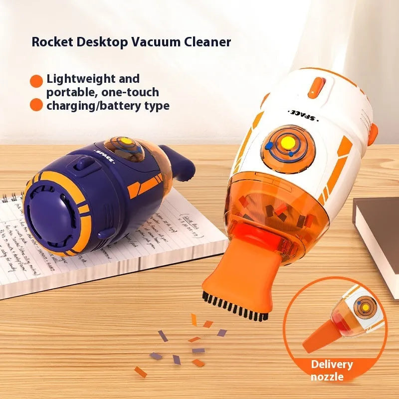 Handheld USB desktop vacuum cleaner in blue rocket design on a wooden desk next to a keyboard.