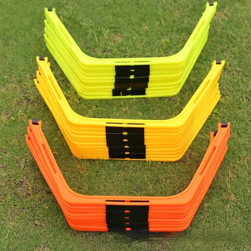 Six foldable hexagon agility training rings in green, orange, and yellow colours laid out on grass.