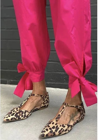 Women's leopard print pointed toe pumps with a low chunky heel and ankle straps.