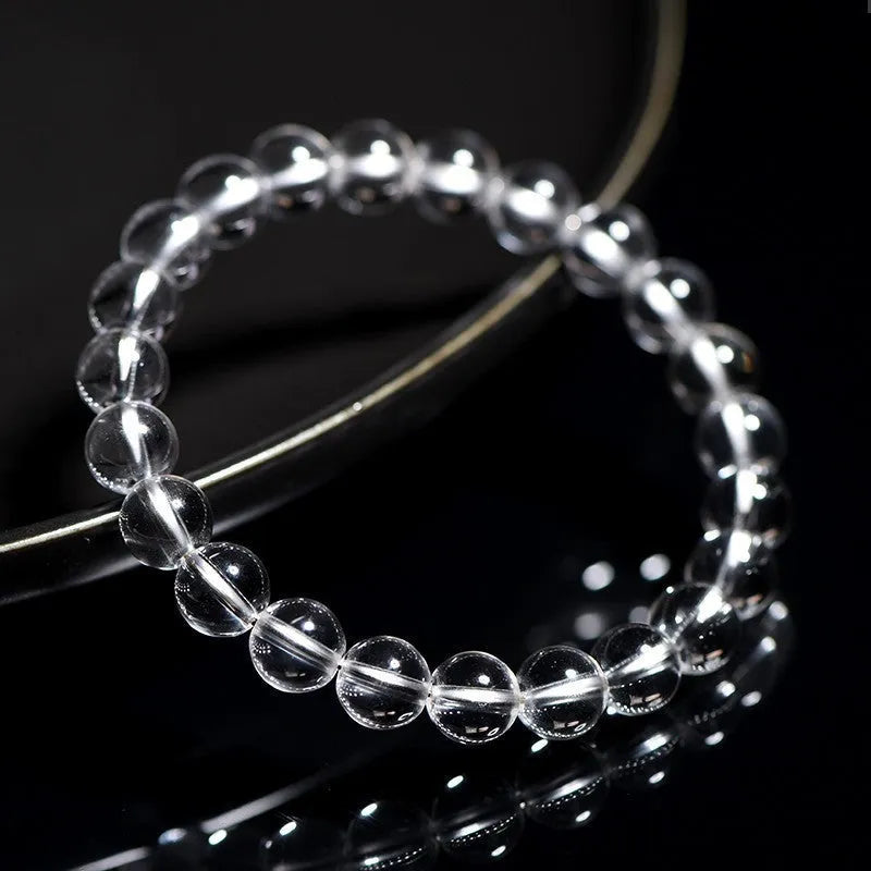 Natural Donghai white water round crystal bead bracelet on a wrist, showing geometric style.