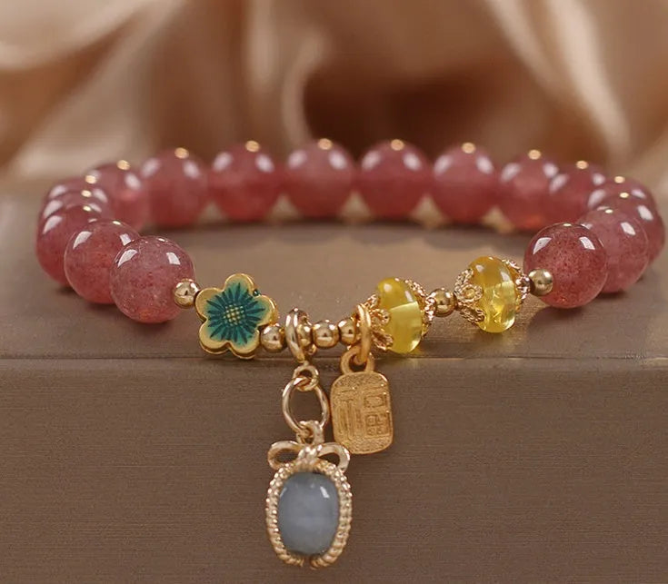 Red strawberry quartz bead bracelet with alloy chain and sparkling rhinestone details.