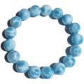 Blue and natural toned bodhi bracelet with a sea-pattern crystal stone centre and pearl accent.
