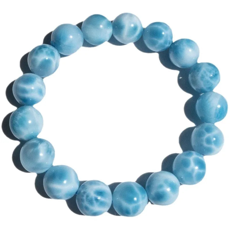 Blue and natural toned bodhi bracelet with a sea-pattern crystal stone centre and pearl accent.