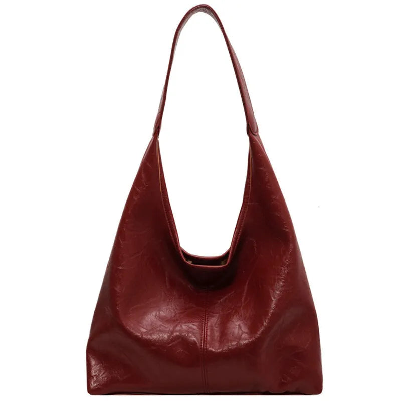 Casual soft PU leather shoulder bag in street trend style with large capacity and sandwich pocket.