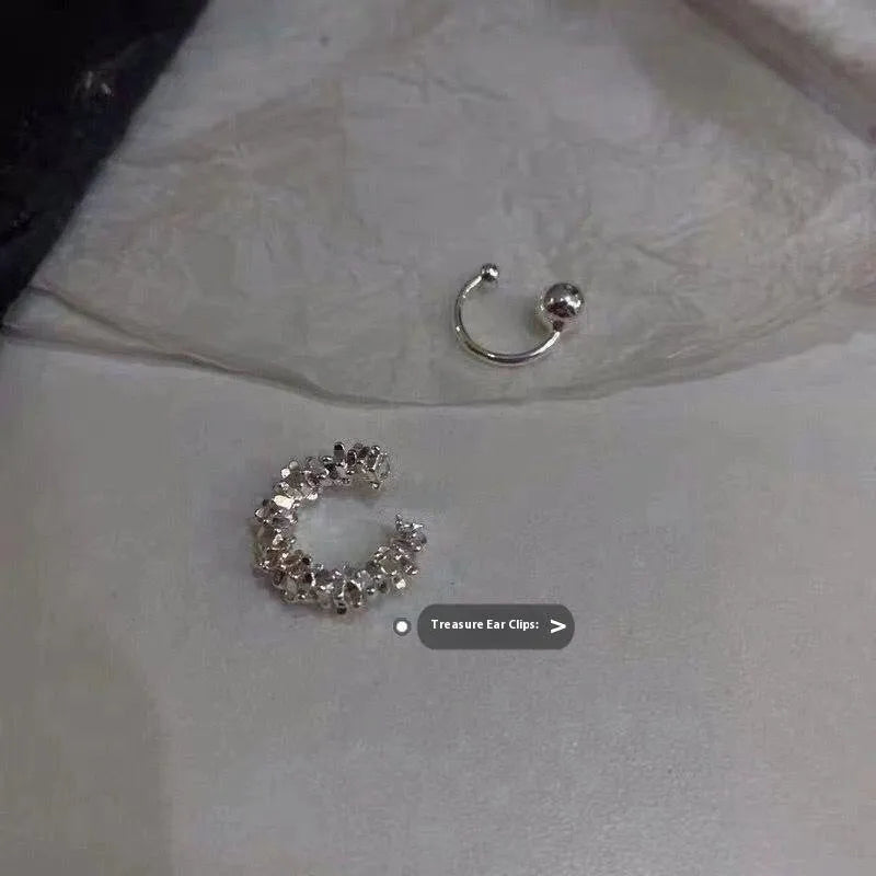 Pair of geometric-shaped alloy ear clips with a frosty finish and double clip mechanism.