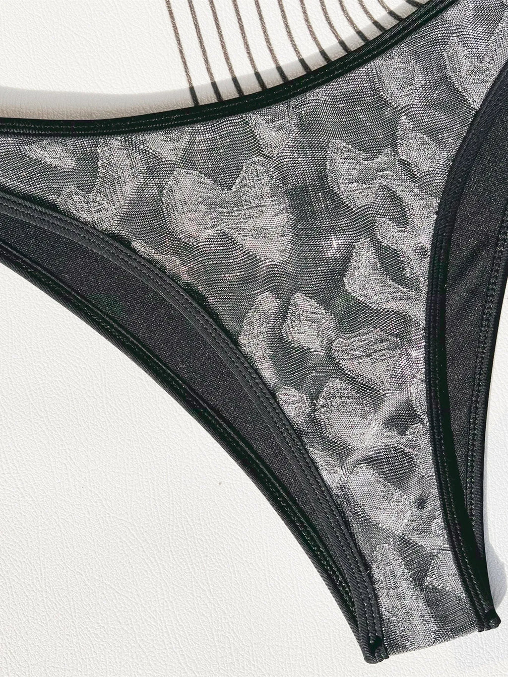 Black polyester ladies bikini set with straps, shown for swimming.