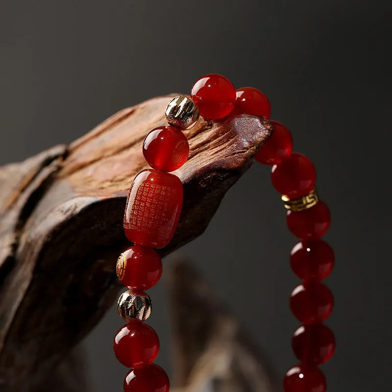 New Chinese style red agate Guanyin bracelet with auspicious patterns on a wrist.