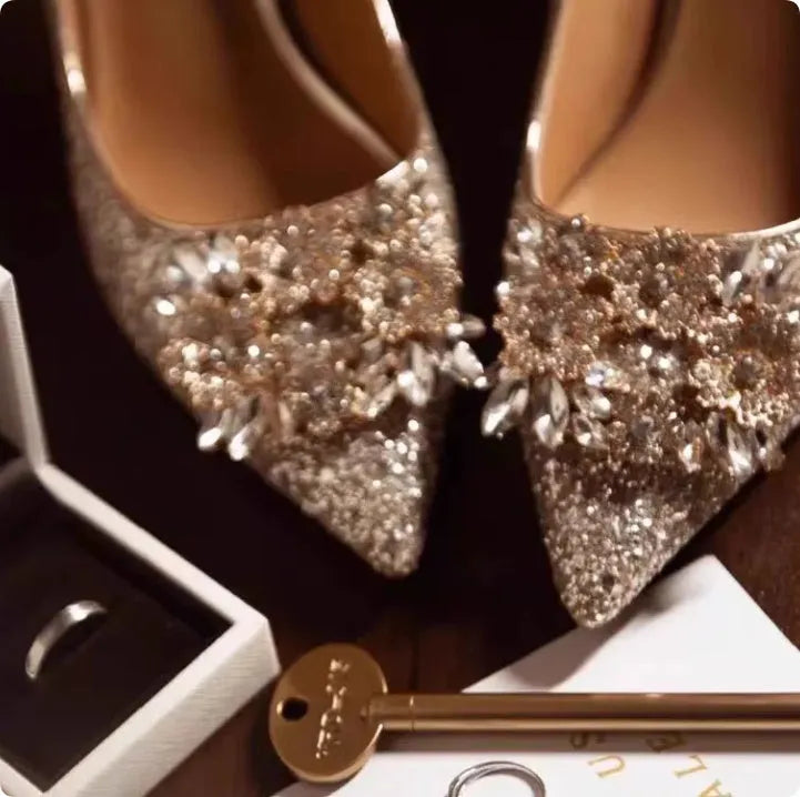 Champagne coloured women's wedding shoes with crystal rhinestones and a pointed toe, shown with a high heel.