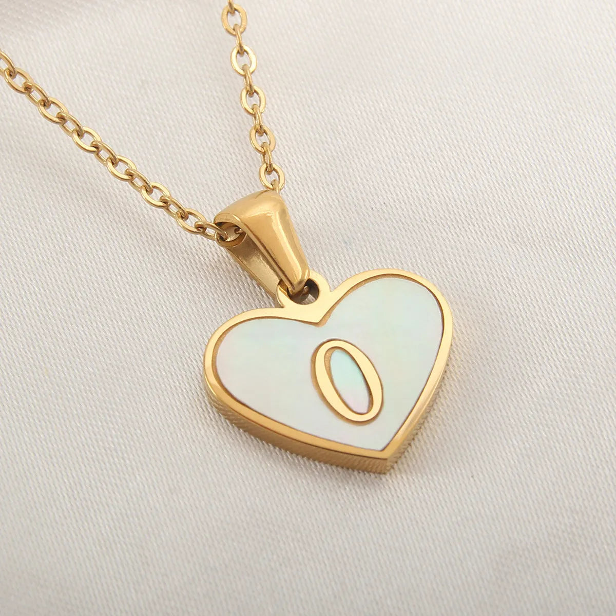 Gold plated heart necklace with white shell detail on an adjustable chain