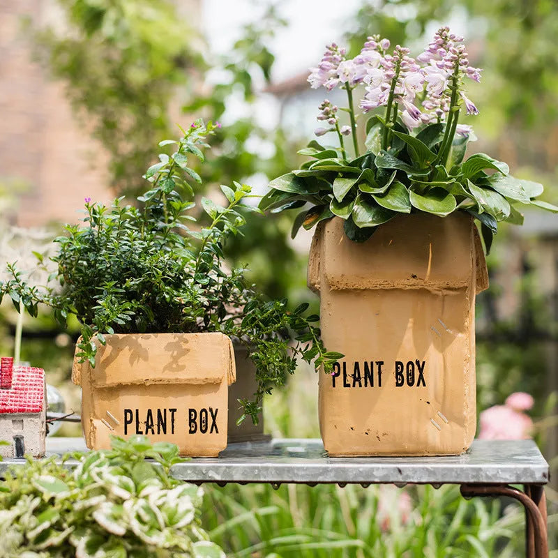 Cement flowerpot with perforated base and imitation carton paper texture for indoor planting