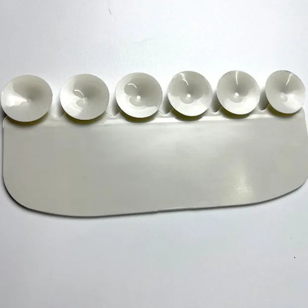 White PVC toilet training splash guard placed on a toilet seat.