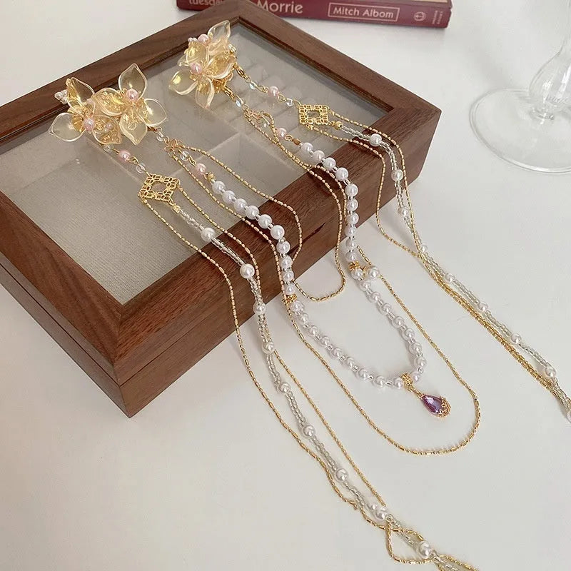 Gold women's hairpin with pearl, diamond and flower design featuring long tassel decoration