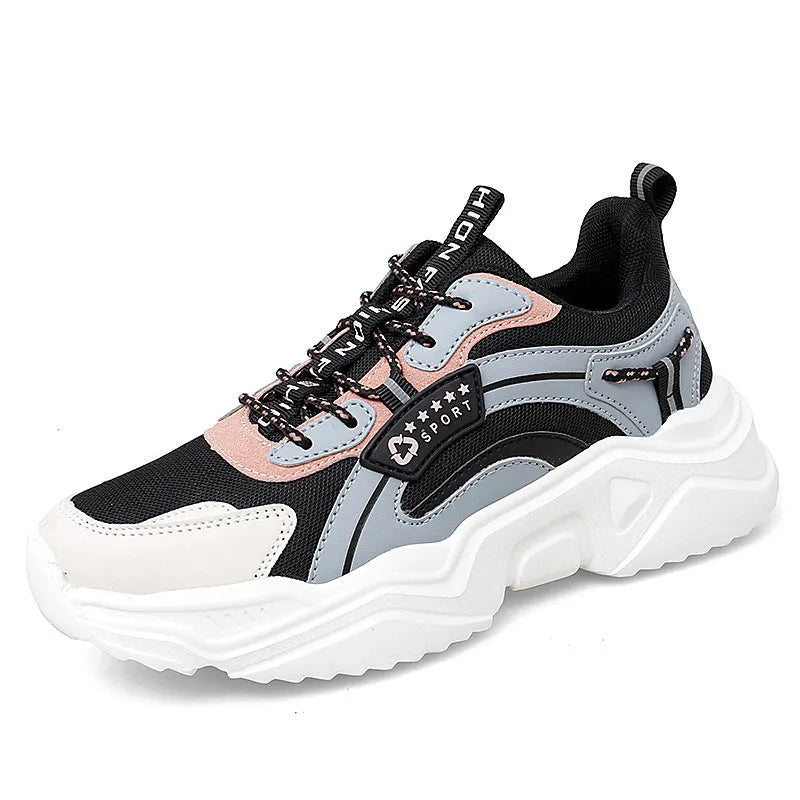 Women's white thick-soled casual sneakers with mesh upper, round toe, and buckle detail.