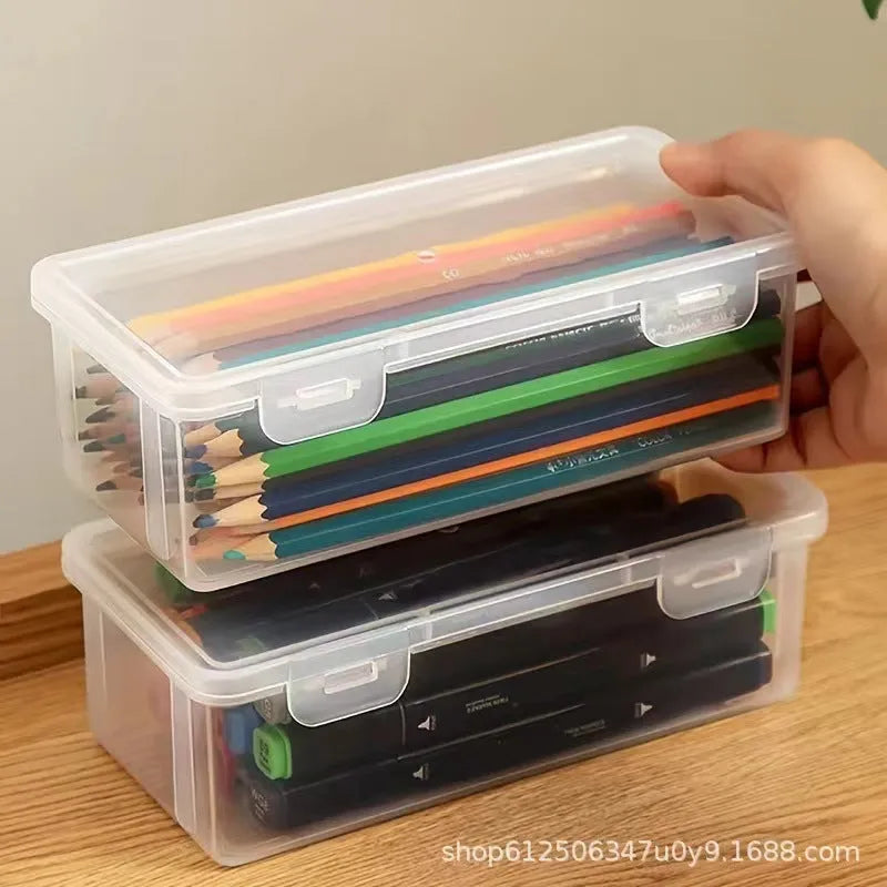 Transparent plastic storage box containing coloured pencils and drawing materials