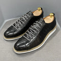 Men's low-top handmade shoes with embossed pattern and front-tie laces.