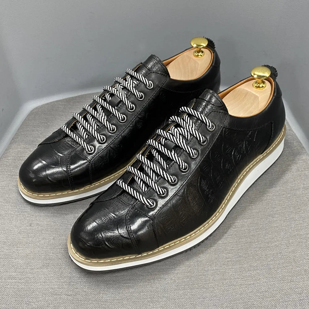 Men's low-top handmade shoes with embossed pattern and front-tie laces.