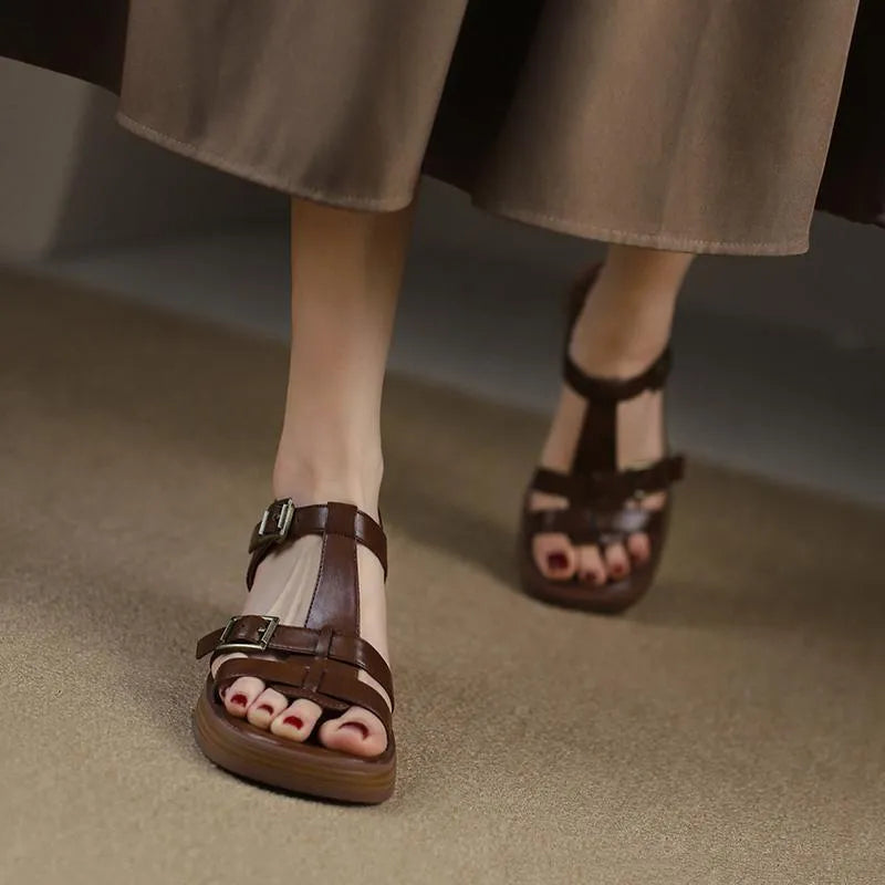 Women's black retro platform sandals with a T-shaped buckle strap and chunky heel.