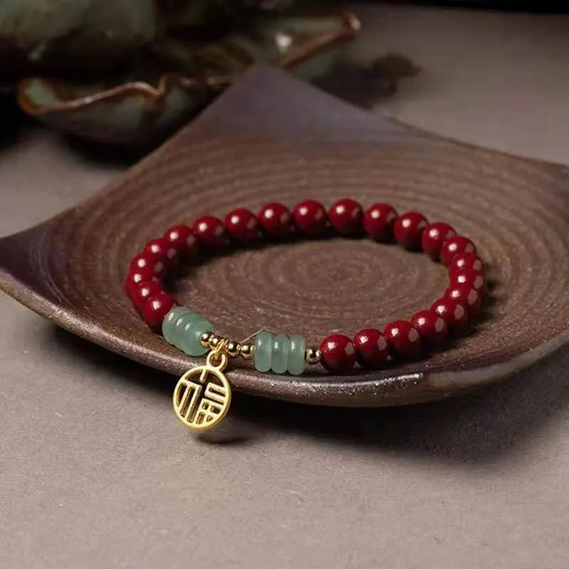 Handmade wave-shaped bracelet made from cinnabar and copper beads in a national unisex style.