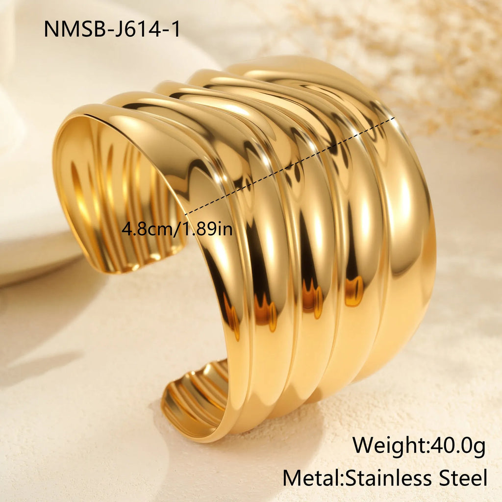 Women's exaggerated wide stainless steel bracelet with 18K gold plating and wave geometric design.