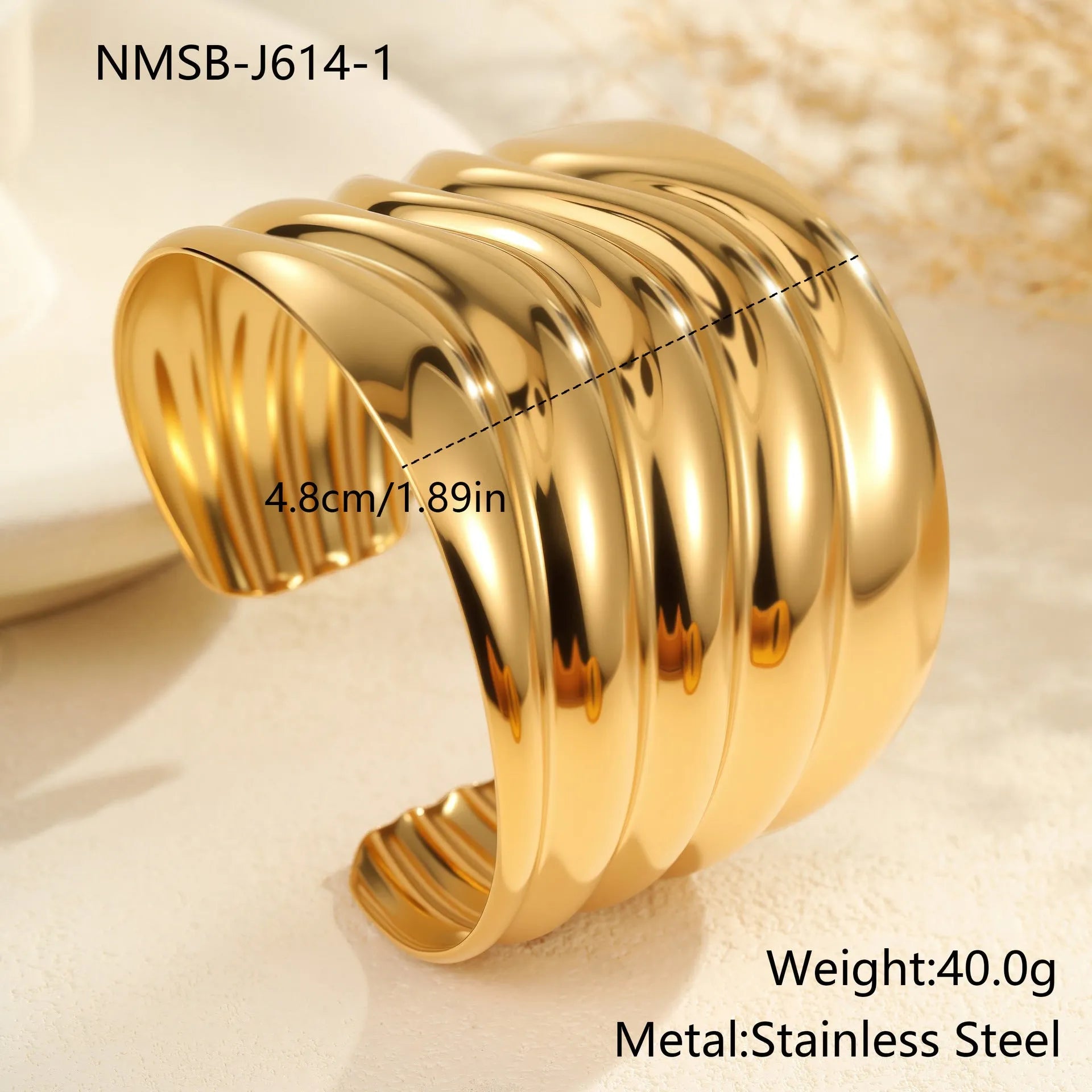 Women's exaggerated wide stainless steel bracelet with 18K gold plating and wave geometric design.